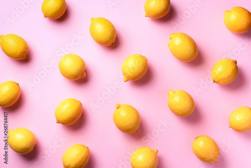 Food pattern with lemons on pink paper background. Top view. Summer concept. Vegan and vegetarian diet