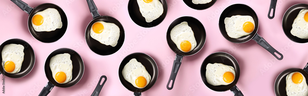 Creative food pattern with fried eggs on pans over pink background. Top view. Creative pattern in minimal style. Flat lay. Banner Creative food pattern with fried eggs on pans over pink background. Top view. Creative pattern in minimal style. Flat lay. Banner