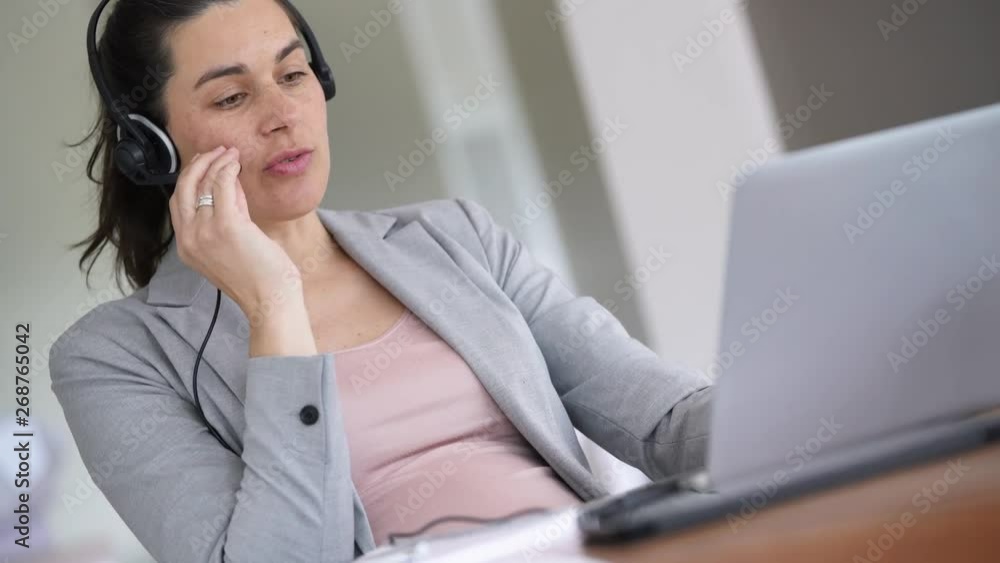 Pregnant businesswoman working as telemarketing assistant Pregnant businesswoman working as telemarketing assistant