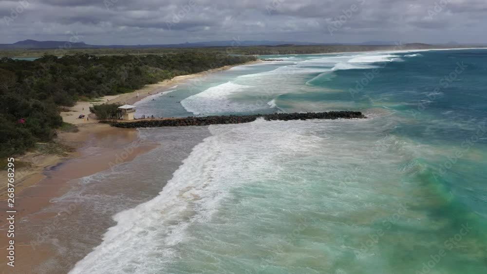 Waves crashing on the wave breaker in Noosa Waves crashing on the wave breaker in Noosa