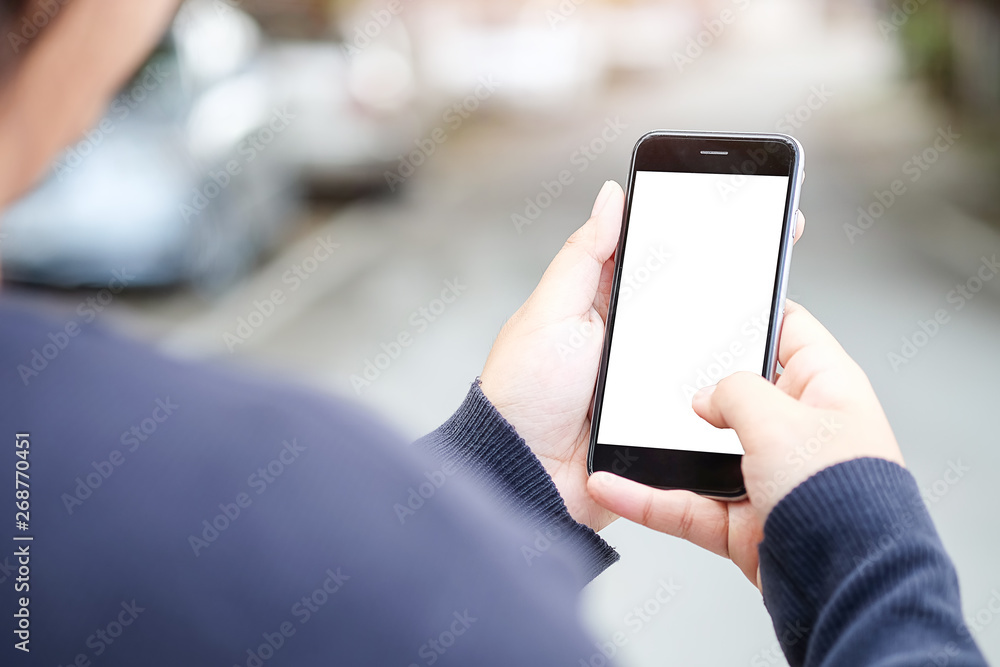 Cropped shot view of man hands holding smart phone with blank copy space screen for your text message or information content, female reading text message on cell telephone during in urban setting. Cropped shot view of man hands holding smart phone with blank copy space screen for your text message or information content, female reading text message on cell telephone during in urban setting.