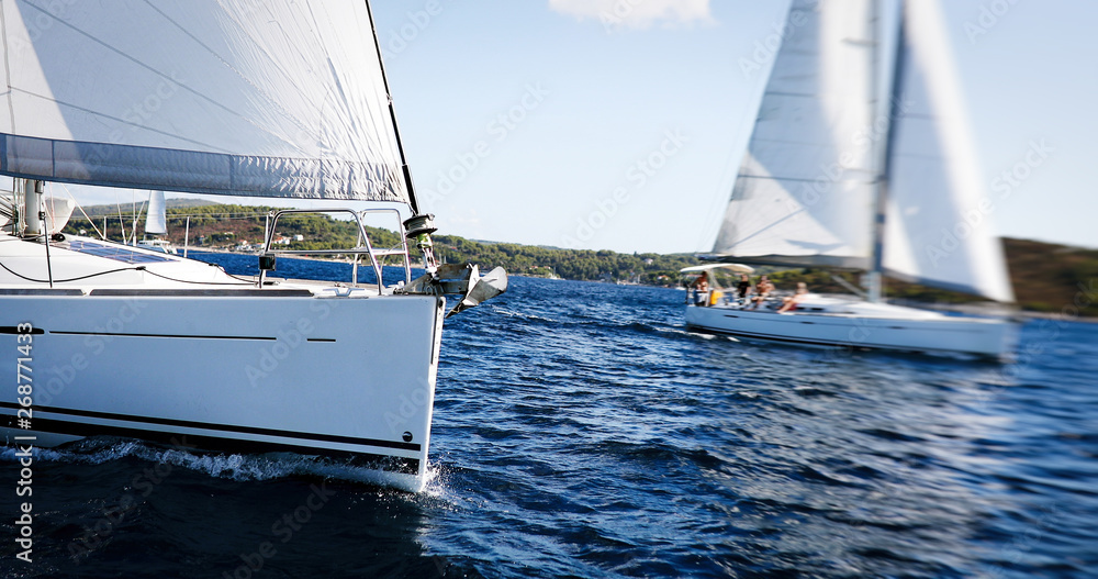 Sailing yachts with white sails in the sea