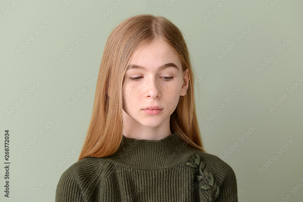 Sad teenage girl on color background Sad teenage girl on color background