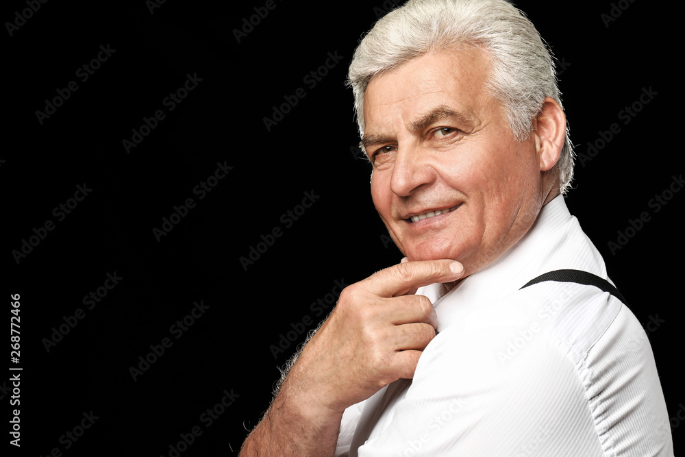 Portrait of handsome senior man on dark background Portrait of handsome senior man on dark background