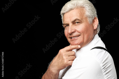 Portrait of handsome senior man on dark background