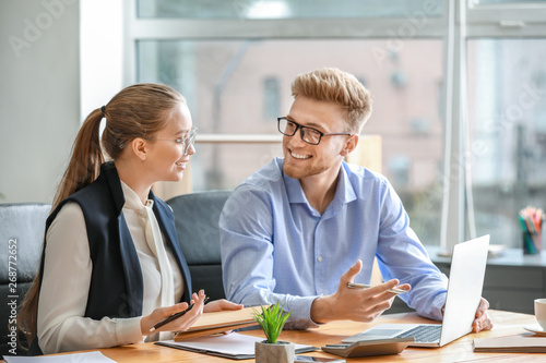 Fotografie Male and female accountants working in office