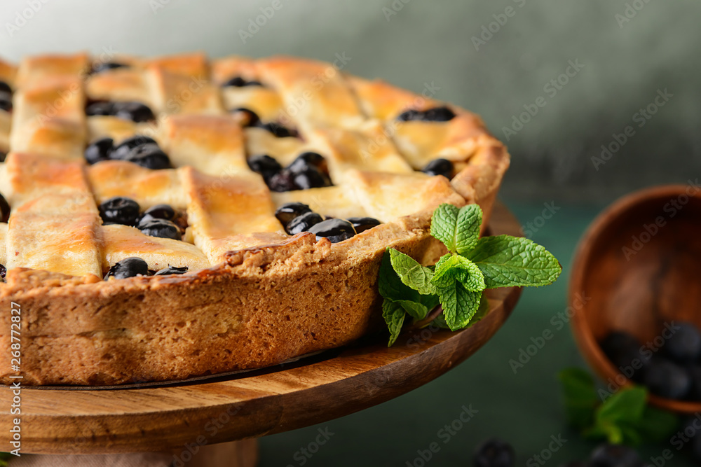 Tasty blueberry pie on dessert stand, closeup