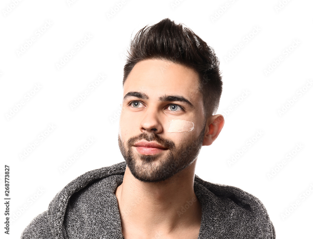 Obraz premium Handsome man with cosmetic clay on his face against white background