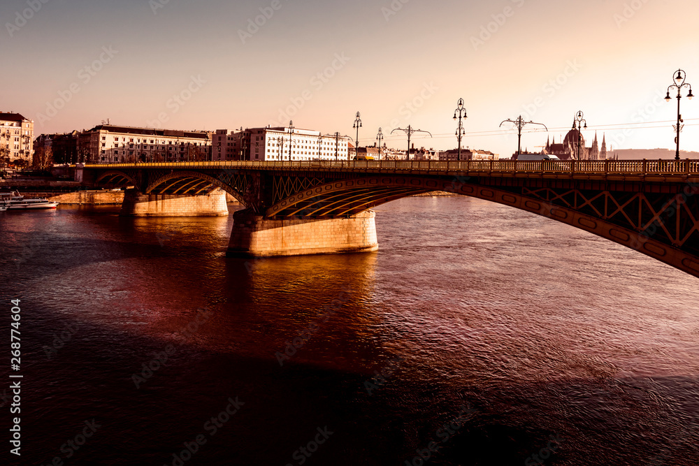 Hungary, Budapest: Skyline panorama with famous Margaret Bridge or Margit hid over Danube Donau river against dramatic afternoon sunlight in the city center of the Hungarian capital - concept travel