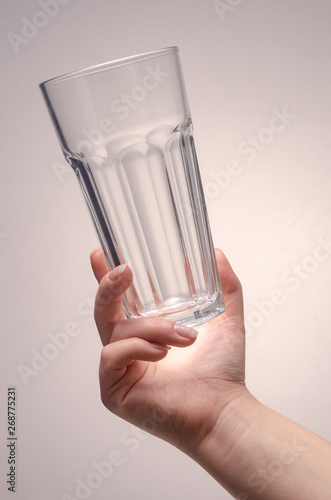 hand holding a glass on a white background. isolate