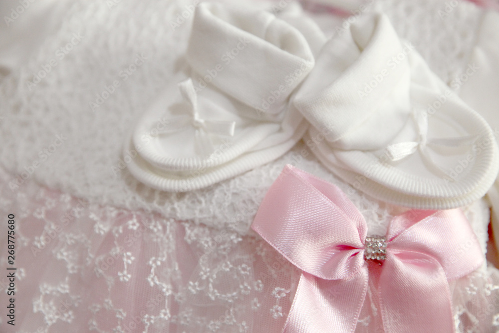 A newborn baby girl background. Close-up of baby shoes A newborn baby girl background. Close-up of baby shoes