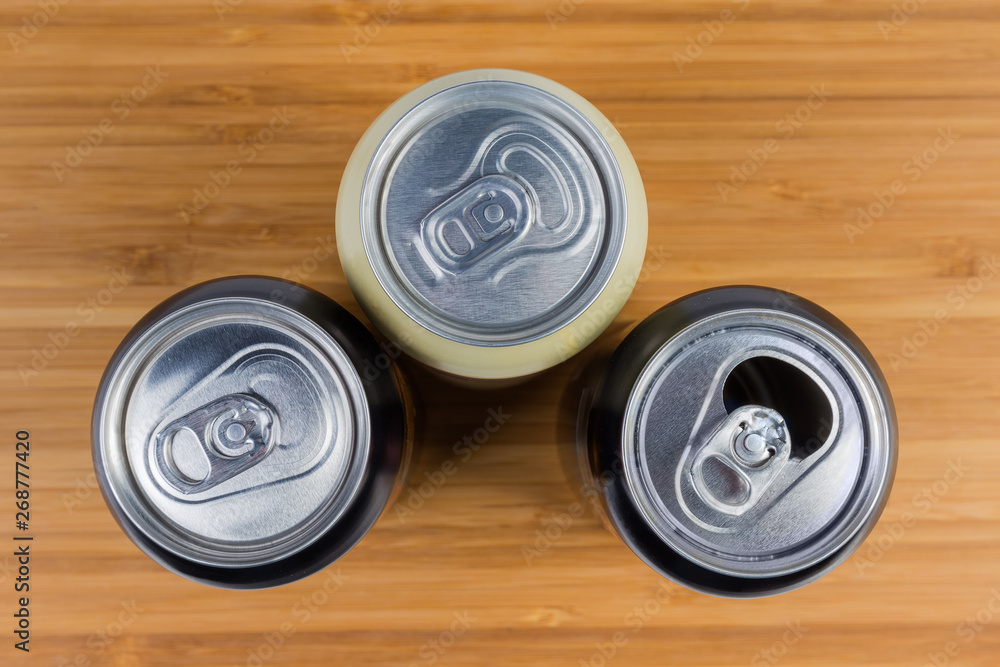 Top view of sealed and open beverage cans close-up Top view of sealed and open beverage cans close-up