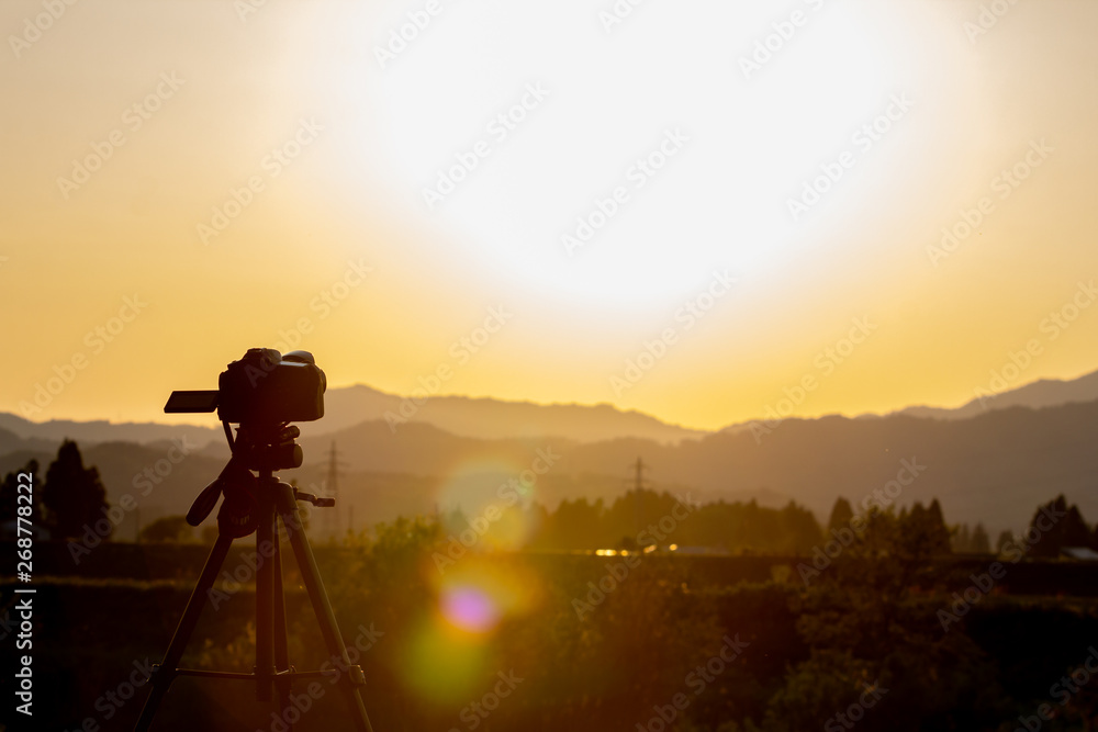 デジタル一眼レフカメラで美しい夕日を撮影している