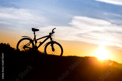 Mountain bike on the background of sunset.