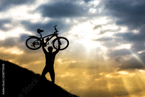 Cyclist man silhouette and mountain bike.