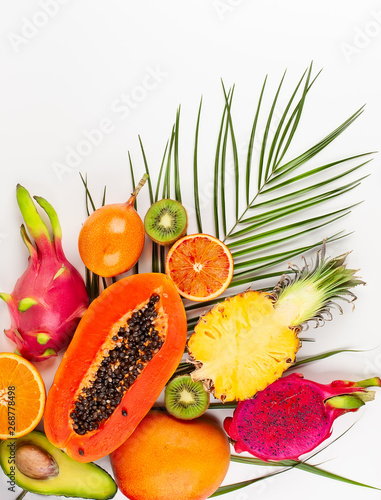Fototapeta Naklejka Na Ścianę i Meble -  Still life with fresh assorted exotic fruits on a palm leaf.