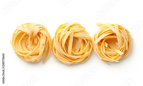 Raw Tagliatelle Pasta Nests Isolated On White Background