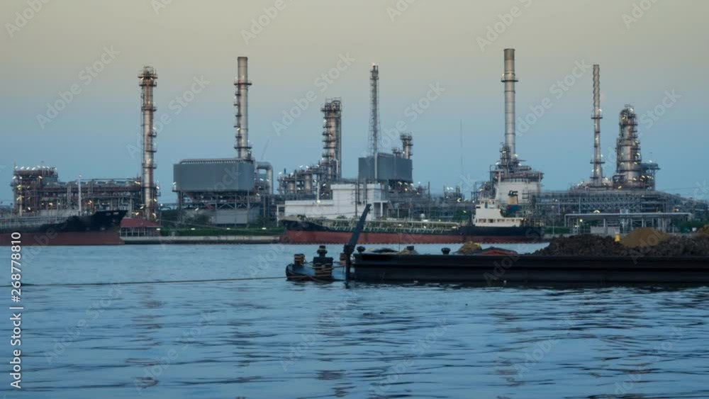 Oil Refinery Factory with Reflection on the river Time-lapse dusk to night, Lockdown. Oil Refinery Factory with Reflection on the river Time-lapse dusk to night, Lockdown.
