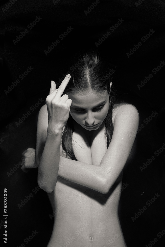Black Hands White Pussy - a black and white photograph in which a naked girl with one hand covers her  breast, the other shows no decent gesture. Stock Photo | Adobe Stock