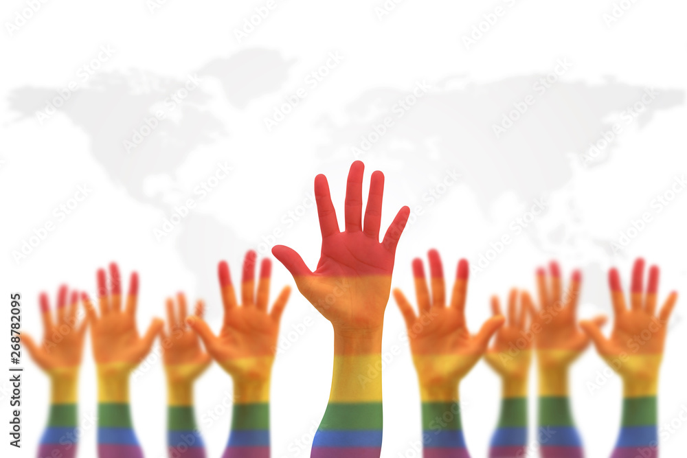 LGBT equal rights movement and gender equality concept with rainbow flag on people's hands up