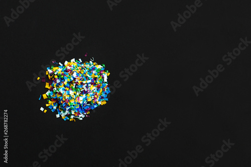Microplastic on black background . Threat to human health and environment Dangerous additives Toxic substances.