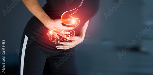 Woman touching stomach painful suffering from stomachache causes of menstruation period, gastric ulcer, appendicitis or gastrointestinal system disease. Healthcare and health insurance concept