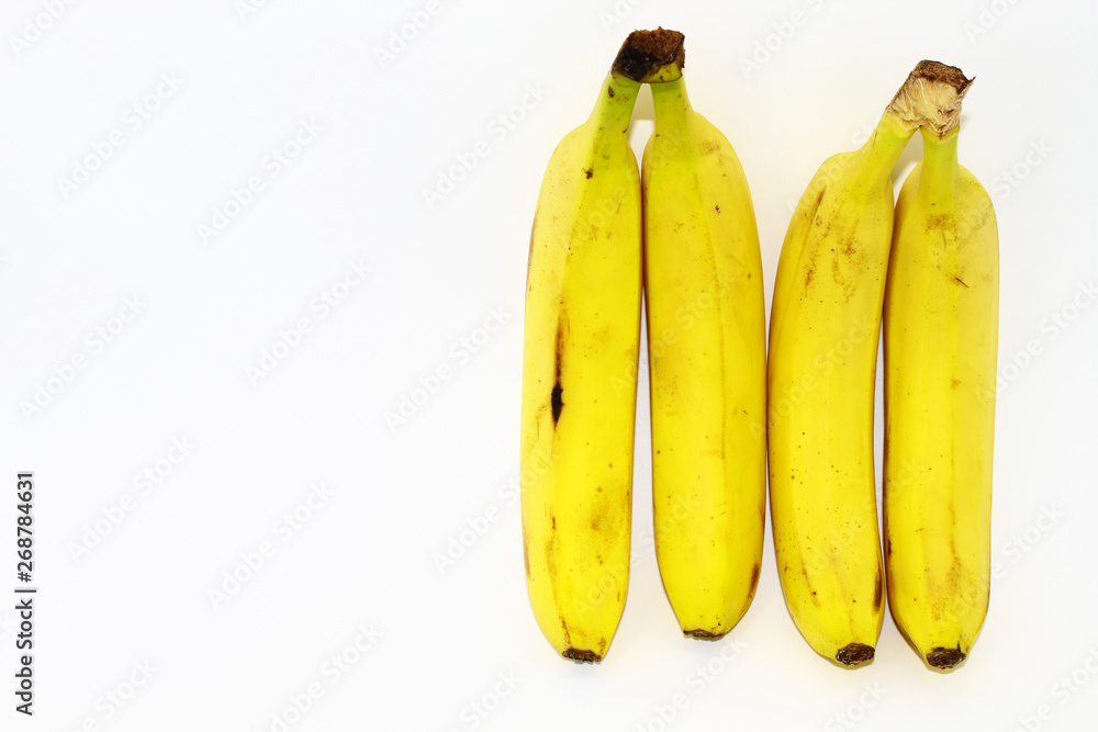 Four fresh yellow bananas. White background