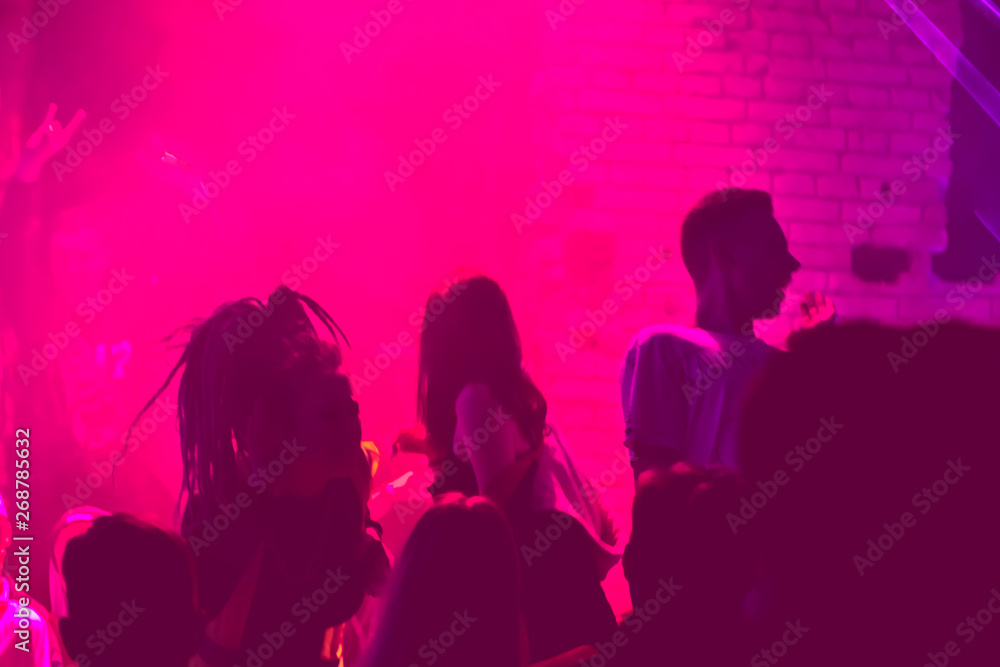 group of people dancing in the club
