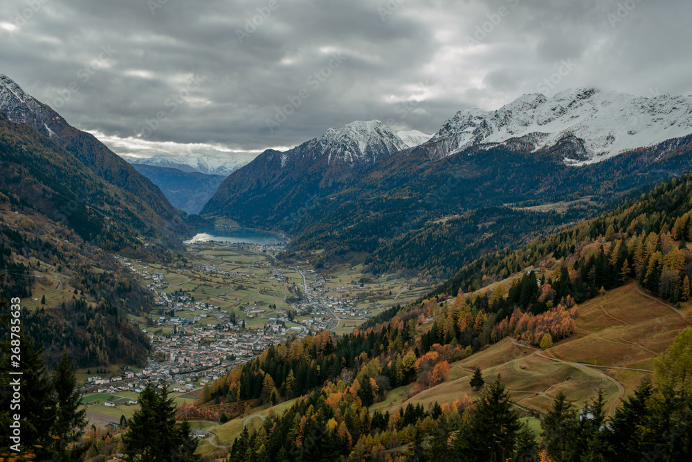 Scenic view from the train to the valley in Switzerland. Small town and lake among town in Switzerland. Adventure in journey. Beautiful nature in autumn. Travel to Europe