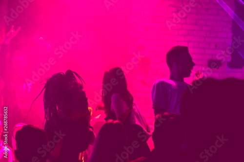 group of people dancing in the club