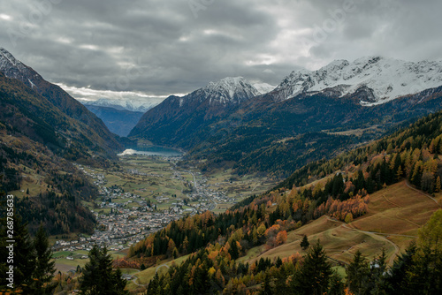 Scenic view from the train to the valley in Switzerland. Small town and lake among town in Switzerland. Adventure in journey. Beautiful nature in autumn. Travel to Europe