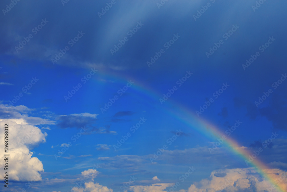 a beautiful rainbow in the blue sky