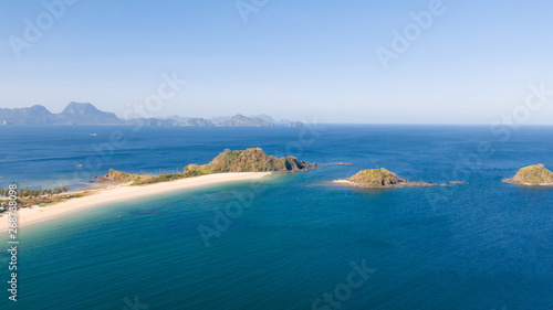 Wide tropical beach with white sand and small islands  top view. Nacpan Beach El Nido  Palawan. Seascape in clear weather  view from above.