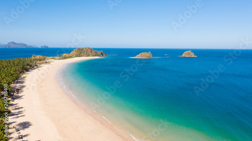 Wide tropical beach with white sand and small islands, top view. Nacpan Beach El Nido, Palawan. Seascape in clear weather, view from above. © Tatiana Nurieva