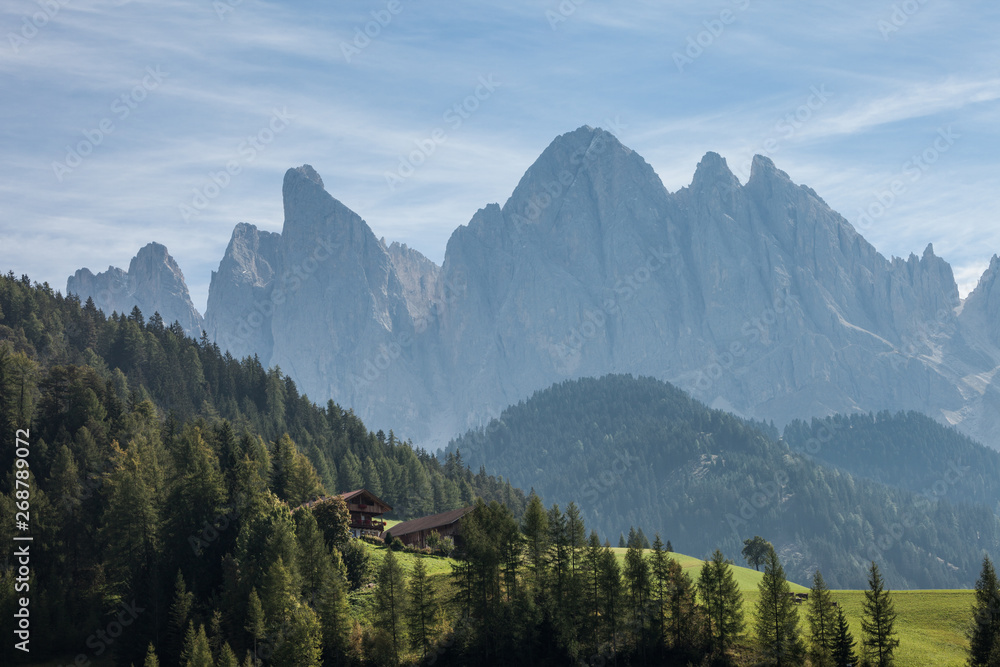 green pasture over the odle group in Dolomites