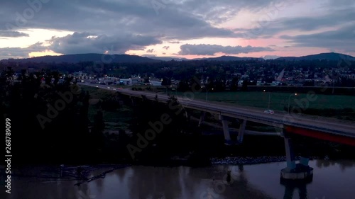 Aerial view of the Mission River bridge at dusk with cars commuting across it. photo