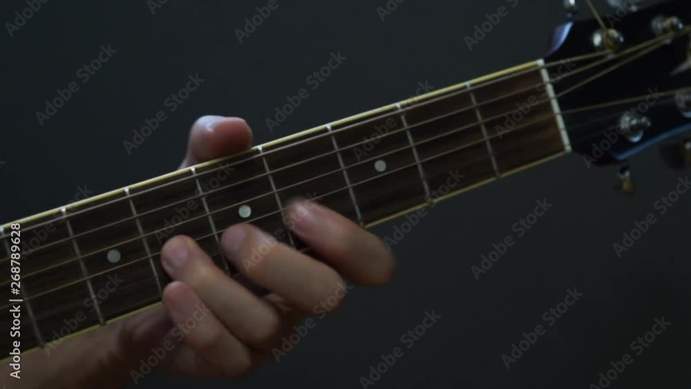 Guitarist playing guitar in studio - close-up of the fingerboard and hand playing fast jazz phrase Guitarist playing guitar in studio - close-up of the fingerboard and hand playing fast jazz phrase