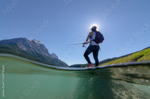 under water view of a girl fishing in banff national park canada