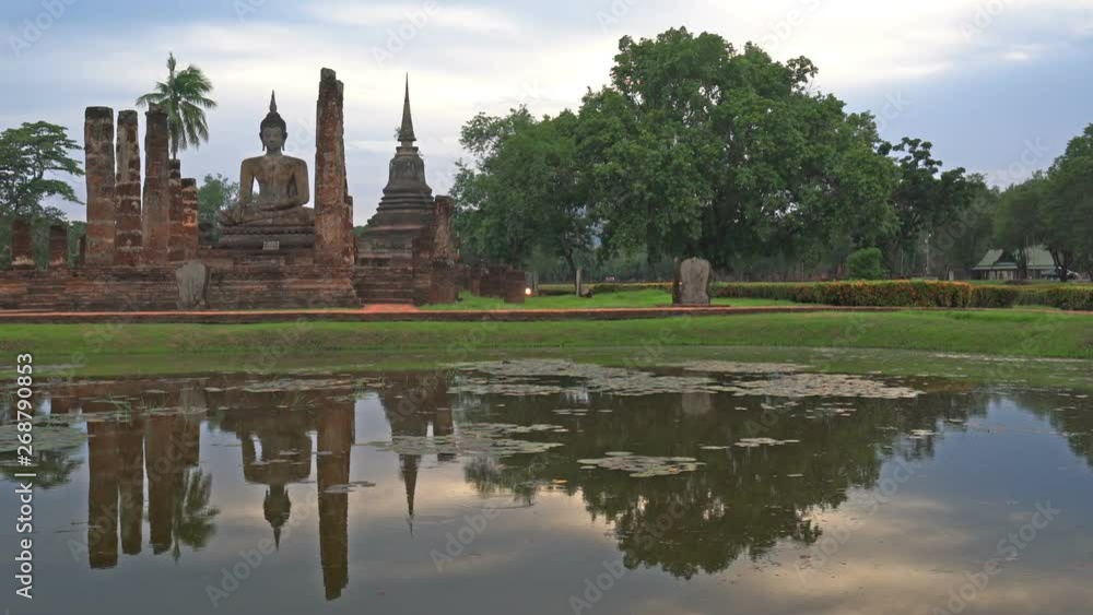 WS View of Sukhothai Historical Park, Mahathat temple reflecting in water, Thailand, Panning Left, Panning. WS View of Sukhothai Historical Park, Mahathat temple reflecting in water, Thailand, Panning Left, Panning.