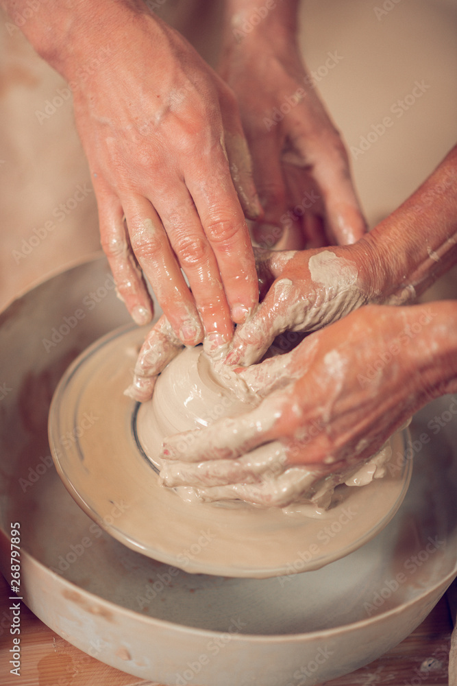 Close up of artists hands being in clay