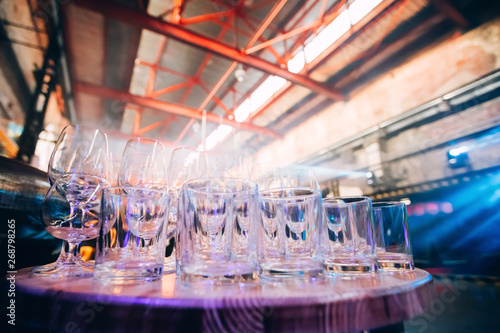 Many Empty whiskey and wine glasses on loft background