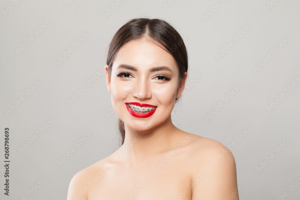 Happy girl in braces smiling on white background Happy girl in braces smiling on white background