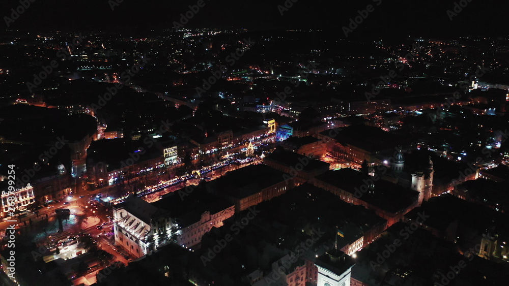 Lviv, Ukraine - 4, January 2019. Arial shot. Rynok square street. Christmas Fair. Lvov Town Hall. Christmas decorations and lights. Night time Lviv, Ukraine - 4, January 2019. Arial shot. Rynok square street. Christmas Fair. Lvov Town Hall. Christmas decorations and lights. Night time