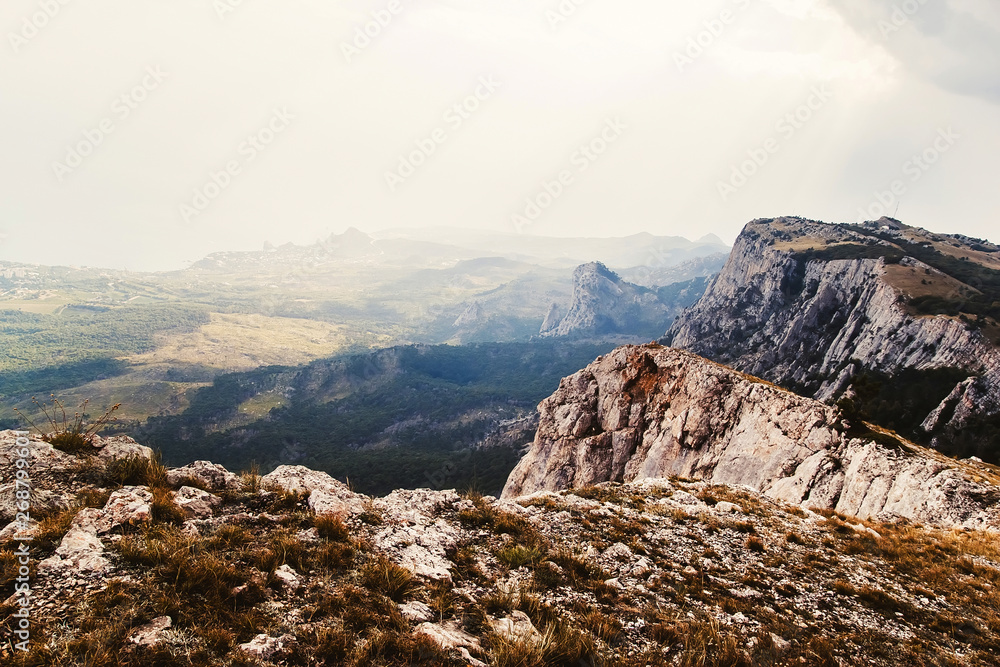 Fototapeta premium mountain landscape in the sun. mighty mountains. view from the mountains to the sea. rocky mountains and blue sky. Clouds hanging over the mountains.