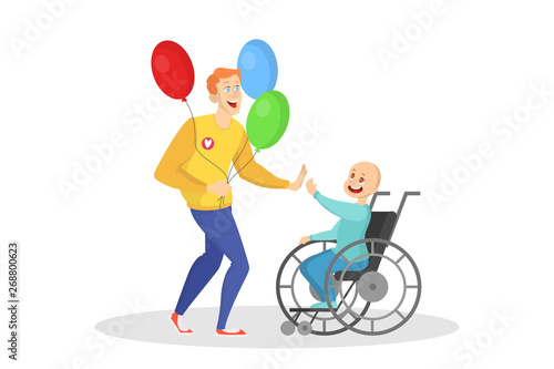 Volunteer playing with a child in a wheelchair