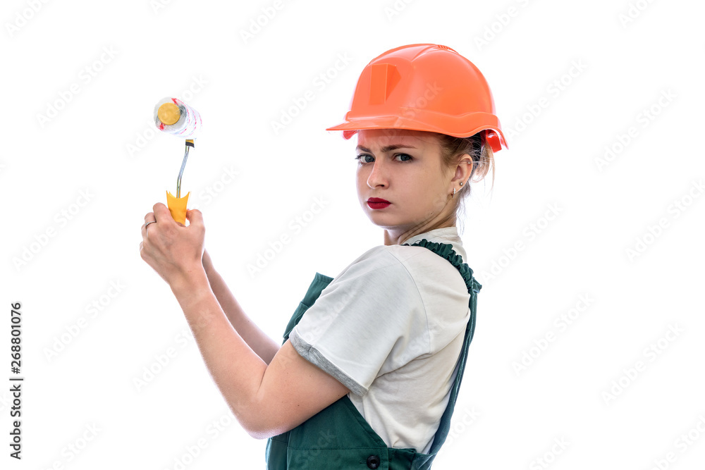 Young woman in helmet holding roller isolated on white Young woman in helmet holding roller isolated on white