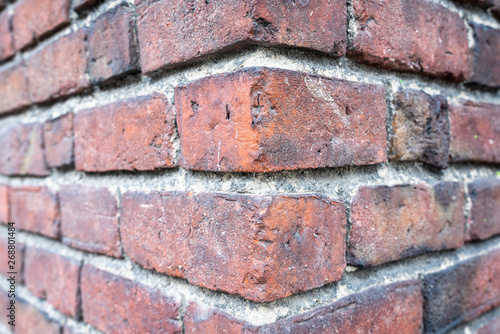 Bricks texture. Dark red brick wall. Corner of old brick building. Colorful red and brown brick wall background.