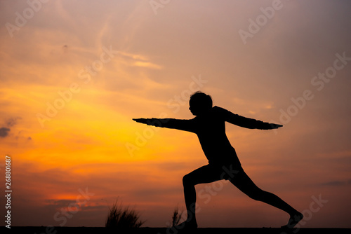 Fototapeta Naklejka Na Ścianę i Meble -  Silhouette Asia woman yoga on sunset. - Image