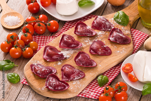 Red heart ravioli with tomato, mozzarella and basil. 