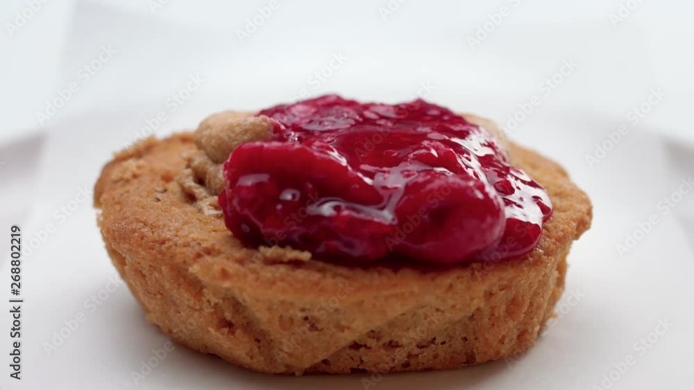 small cake with fruit topping pouring on it. Dessert with red berries and fruits small cake with fruit topping pouring on it. Dessert with red berries and fruits